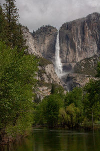 Scenic view of waterfall against sky