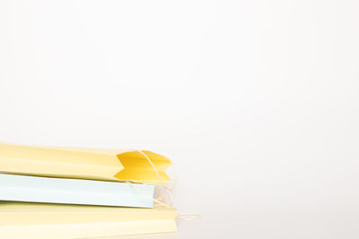 Close-up of yellow paper over white background