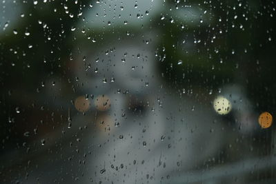 Full frame shot of wet glass window during rainy season