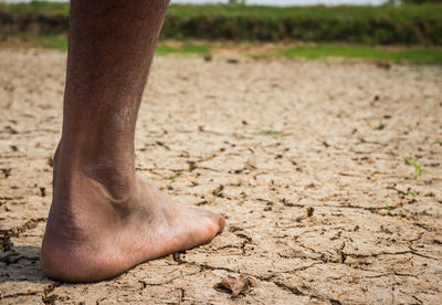 Low section of person on drought land