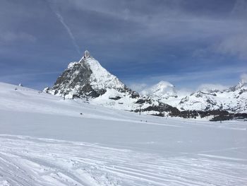 Scenic view of snowcapped mountains against sky