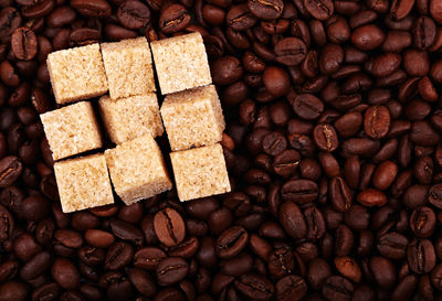 Detail shot of sugar cubes on coffee beans