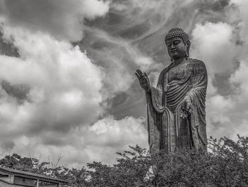 Low angle view of statue against sky