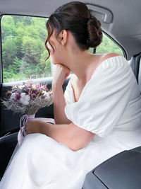 Young woman sitting in car