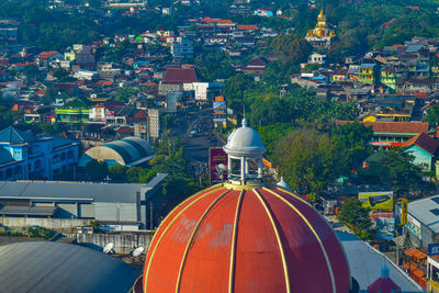 High angle view of trees and buildings in city