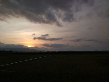 Scenic view of field against sky during sunset