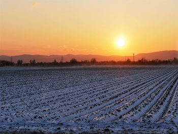 Scenic view of field against sky during sunset