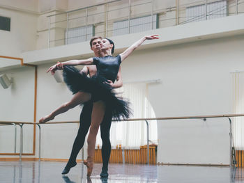 Full length of ballet dancers dancing