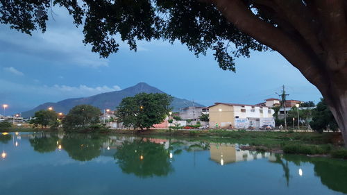 Scenic view of lake by buildings against sky