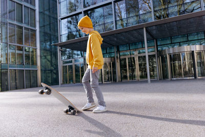 Smiling young teen boy with a skateboard. lifestyle scene