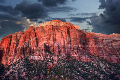 View of rocky mountain against cloudy sky