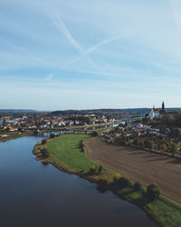 Aerial view of river and buildings against sky