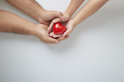 Midsection of couple holding hands
