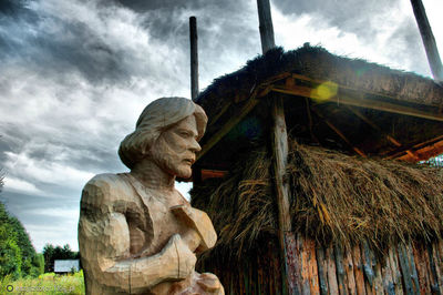 Low angle view of statue against cloudy sky