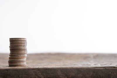 Close-up of coins on table against white background