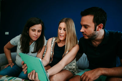 Young couple looking at friends