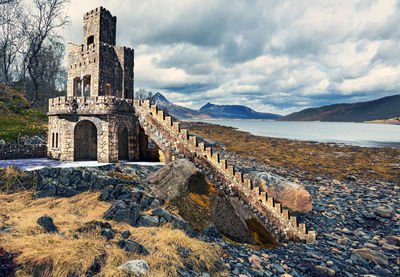 Old ruins of temple against cloudy sky