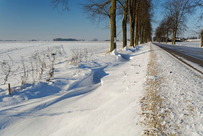 Snow covered landscape against sky