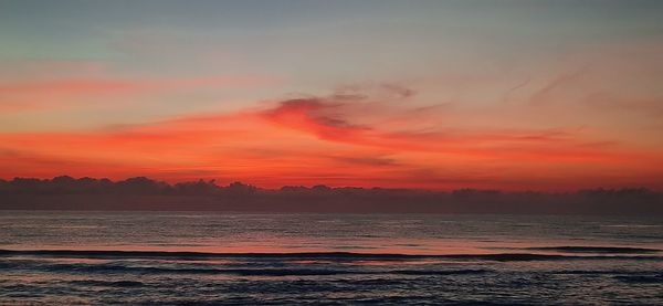 Scenic view of sea against romantic sky at sunset