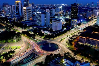 High angle view of illuminated buildings in city at night