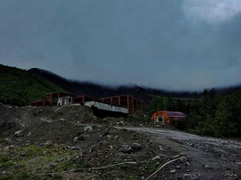 Abandoned car on land against sky