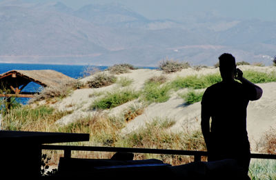 Rear view of man looking at mountains