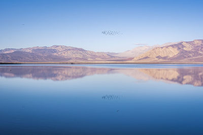 Scenic view of lake against blue sky