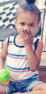 Portrait of cute boy sitting with toy