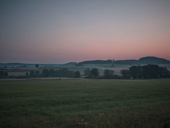 Scenic view of field against sky during sunset