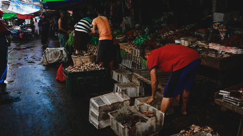 Group of people for sale at market stall