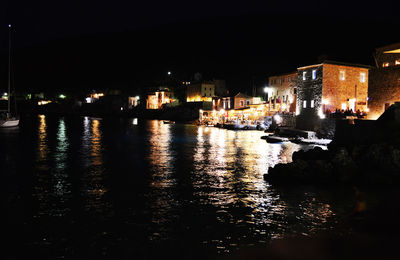 Illuminated buildings with waterfront at night