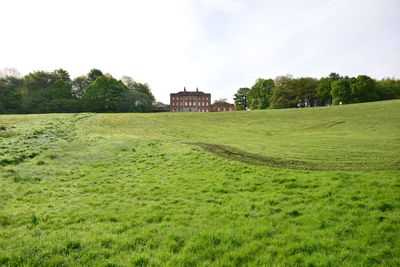 Built structure on field against sky