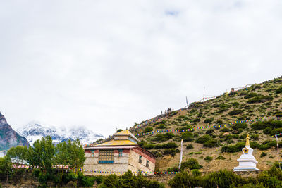 Panoramic view of trees and buildings against sky