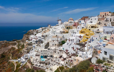 High angle view of townscape by sea against sky