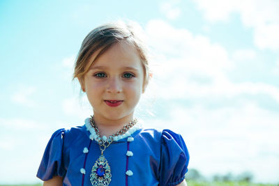 Portrait of smiling girl against sky