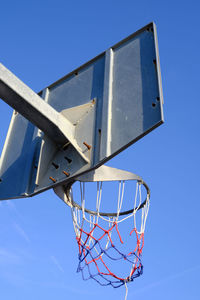 Basketball hoop and net against a blue sky. urban youth game. low angle view. .