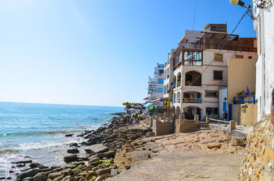 Building on beach against clear sky