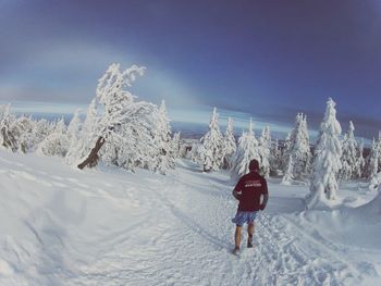 People standing on snow covered landscape