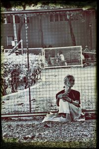 Full length of woman sitting in cage