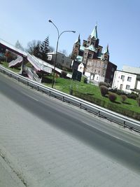 View of buildings against clear blue sky