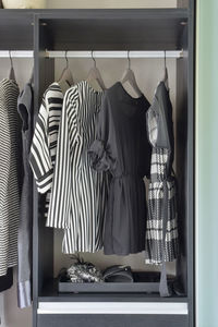 Clothes hanging in cabinet