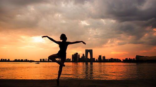 Silhouette of city at sunset