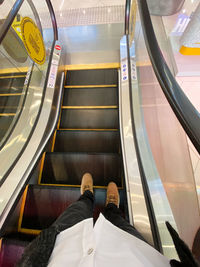 Low section of man on escalator