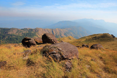 Scenic view of rocks on field against sky