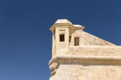 Low angle view of church against blue sky