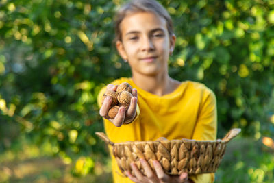 Portrait of young woman holding plant