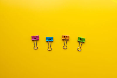 Close-up of objects against yellow background
