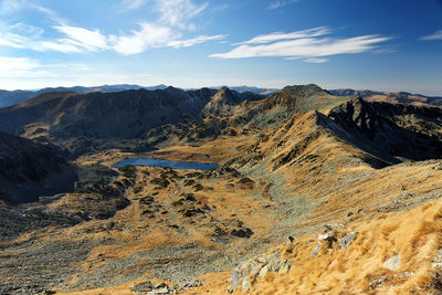 Scenic view of mountains against blue sky