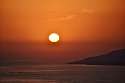 Scenic view of sea against romantic sky at sunset