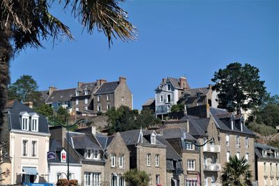 Low angle view of buildings against blue sky